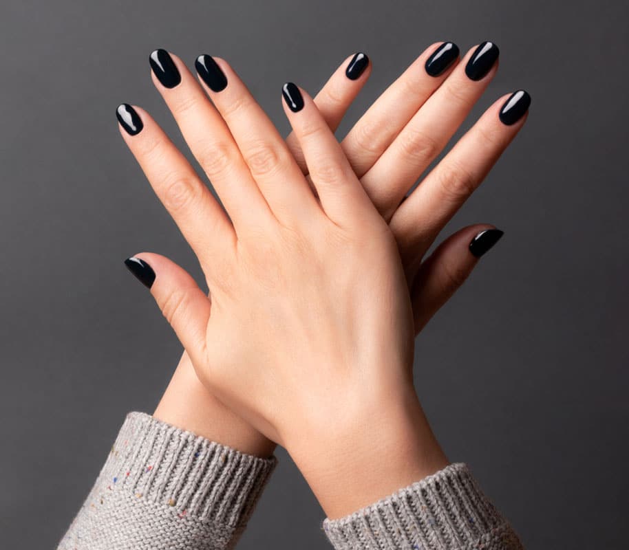 a close up of a hand with beautiful black nails